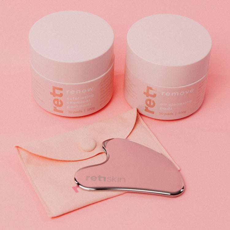 a gua sha tool with two jars of cleansing oil pads and chemical peel pads